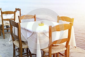 Cafe tables on the sea mediterranean embankment. selective focus. flare.