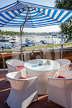 Cafe under a sun umbrella on the shore of yachting