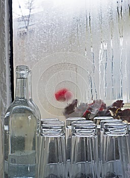 Cafe Water Glasses and Bottle Rainy Window