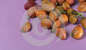 Caferana fruits Bunchosia armeniaca in natura on pink background photo
