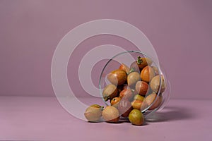 Caferana fruits Bunchosia armeniaca in natura served in a bowl on a pink background photo