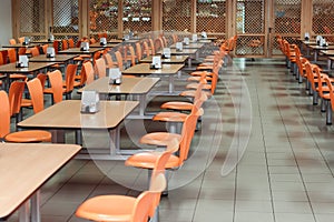 Cafeteria or canteen interior. School cafeteria. Factory canteen with chairs and tables, nobody. Modern cafeteria interior. Clean