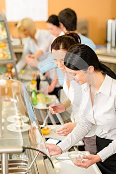 Cafeteria lunch two office woman choose food