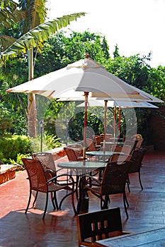 Cafeteria tables and chairs with umbrella shade in Ilocos Norte, Philippines photo