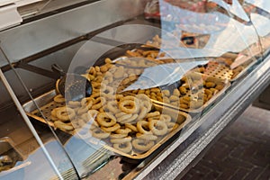 Cafeteria take-out food in showcase window. Many Fried onion rings Sitting in Showcase Display of a Fast-Food.