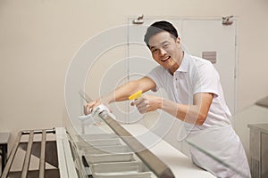 Cafeteria worker cleaning food serving area