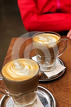 Caffe lattes with bokeh woman body