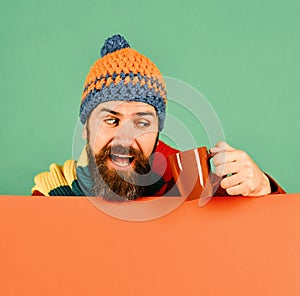 Caffeinated beverages idea. Man in warm hat holds brown cup