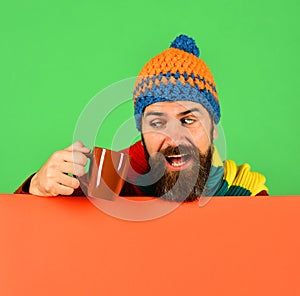 Caffeinated beverages idea. Man in warm hat holds brown cup