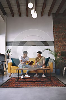 Caffeinated and driven. two young men using a digital tablet while having coffee together.