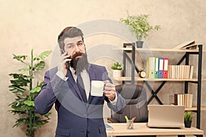 Caffeine addicted. Man bearded businessman hold cup stand office. Successful people drink coffee. Coffee is always good