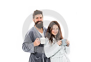 Caffeine power concept. Couple enjoy lazy weekend and drink coffee. Wife and husband bathrobes hold tea mug coffee cup