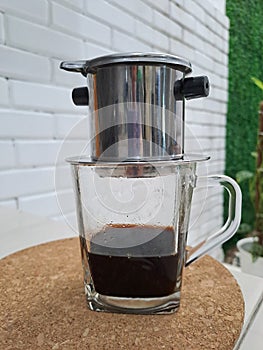 Caffeine - quarter glass of black coffee served in vietnames style