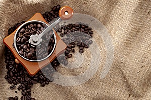 Caffeine rich strong stimulant beverage conceptual idea with detailed close up vintage manual coffee grinder with beans full of