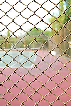 Cage of blurred tennis court background