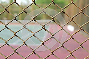 Cage of blurred tennis court background