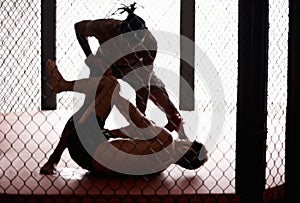 Cage, fight and men sparring for competition, challenge and fitness in mixed martial arts action. Battle, kick boxing