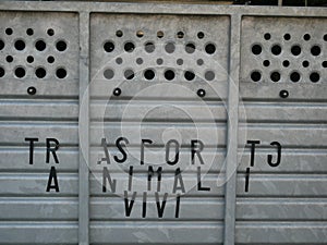 A cage  with `trasporto animali vivi` writer on it