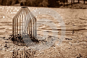 Caged pond overflow spillway cover with buildup