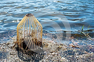 Caged pond overflow spillway cover with buildup