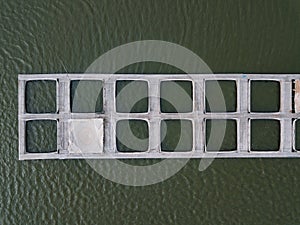 Cages for sturgeon fish farming in natural river or pond, top view