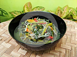 Cah kangkung or tumis kangkung, stir fried water spinach, common asian vegetable dish photo