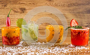Caipirinha, Brazilian national cocktail made with cachaÃÂ§a, sugar cane liqueur and fruit on wooden background