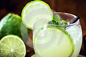 Caipirinha cocktail in glass on wooden table background. Copyspace, bar menu image, international caipirinha day, 13th September