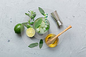 Caipirinha, Mojito cocktail, vodka or soda drink with lime, mint and straw on table background. Refreshing beverage with