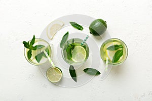 Caipirinha, Mojito cocktail, vodka or soda drink with lime, mint and straw on table background. Refreshing beverage with