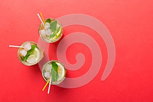 Caipirinha, Mojito cocktail, vodka or soda drink with lime, mint and straw on table background. Refreshing beverage with