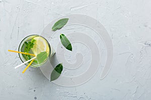 Caipirinha, Mojito cocktail, vodka or soda drink with lime, mint and straw on table background. Refreshing beverage with