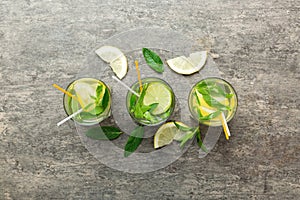 Caipirinha, Mojito cocktail, vodka or soda drink with lime, mint and straw on table background. Refreshing beverage with