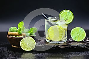 Caipirinha, a typical Brazilian cocktail made with lemon, cachaÃ§a, sugar and ice, Ingredients on the side. Sugar, Cinnamon,