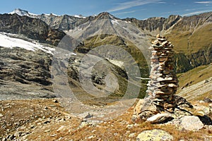 Cairn above glacial valley in Swiss Alps