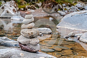 Cairn of balanced stones by the riverside