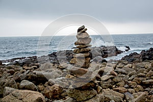 Cairn in front of coastal landscape