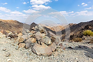 Cairn, human-made pile or stack of stones, marking mountain top in Hatta, Hajar Mountains, UAE