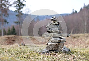 Cairn marking a hiking trail in a clearing in the forest