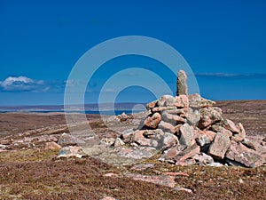 A cairn and pink granite near the neolithic axe factory in the Beorgs of Uyea, Northmavine, Shetland, UK.