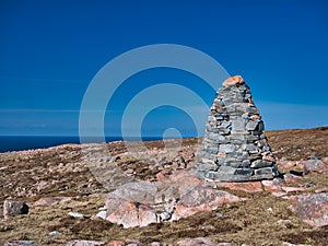 A cairn and pink granite near the neolithic axe factory in the Beorgs of Uyea, Northmavine, Shetland, UK.