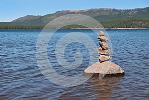 Cairn on a rock in the lake