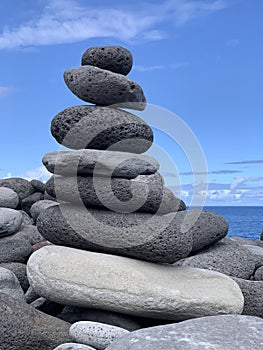 cairn on the shore against the blue sky close-up, balance