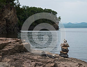 Cairn, stacked stones, on lake shore