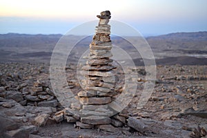 Cairn at sunrise, stones balances, pyramid of stones at sunset, concept of life balance, harmony and meditation. A pile of stones