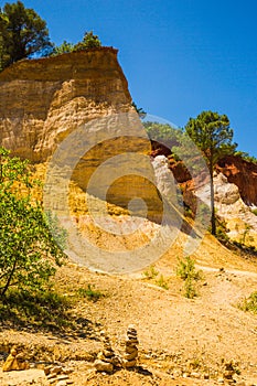 Cairns Formations in front of Colourful Ochres of the French Provencal Colorado in Rustrel France