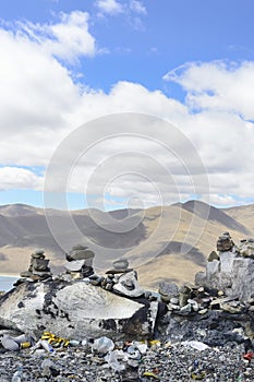 Cairns mark a mountaintop of the Tibetan Plateau in Brahmaputra Valley of the Tibet Autonomous Region of China.