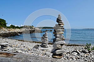 Cairns and rocks along the rocky coastline in Portland Maine