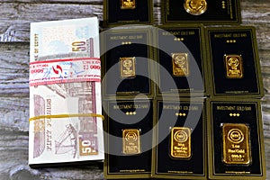 Cairo, Egypt, December 8 2023: 24K karat BTC Bullion Trading Center pure yellow gold of bars and sovereign coin, and a stack of