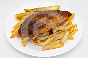 Cajun Blackened Catfish with French Fries on a White Plate